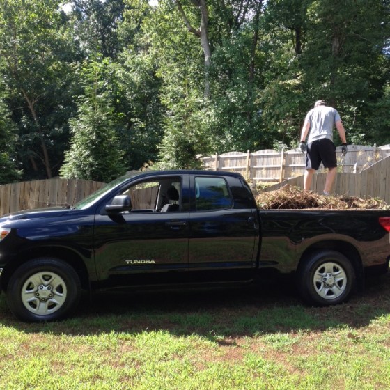 Husband stomping down dirt in his new truck